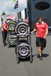Soft-and-medium-tyres-being-handled-by-team-personnel